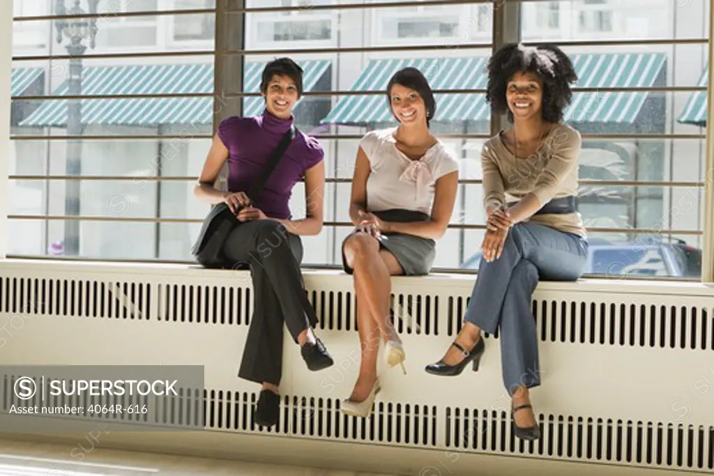 Portrait of three businesswomen sitting in office