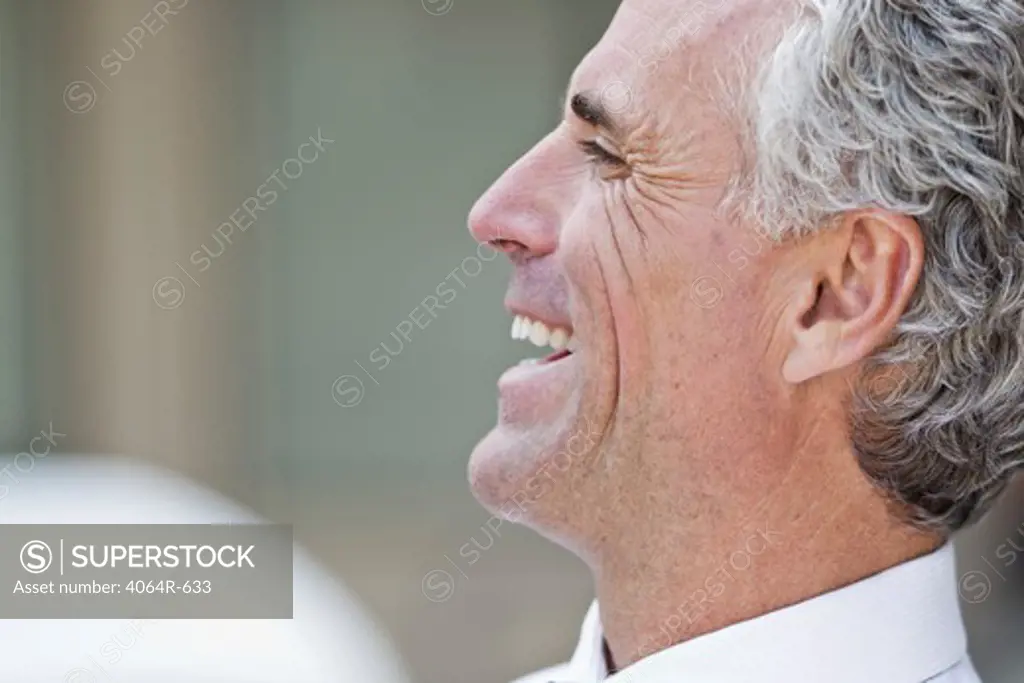Businessman laughing outdoors