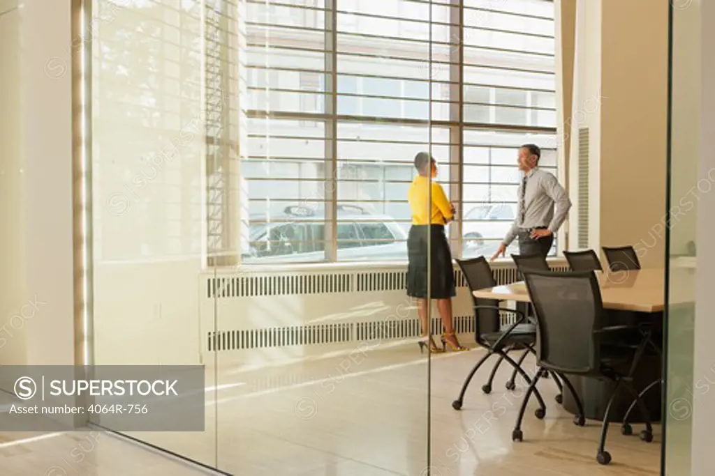 Businessman and woman consulting in boardroom