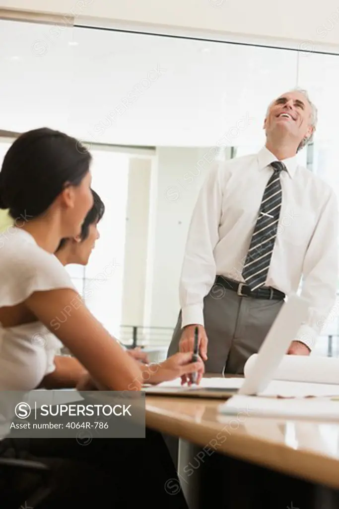 Project discussions amongst employees in boardroom