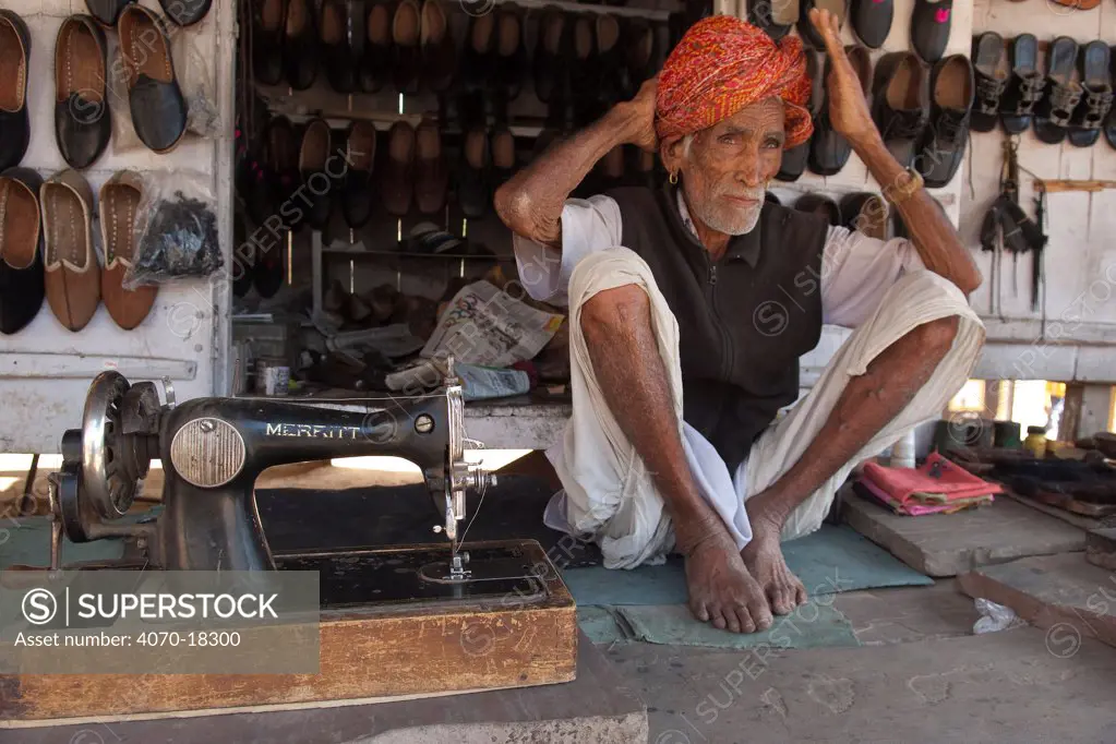 Portrait of elderly Rajasthani man, selling shoes, Rajasthan, India, February 2010