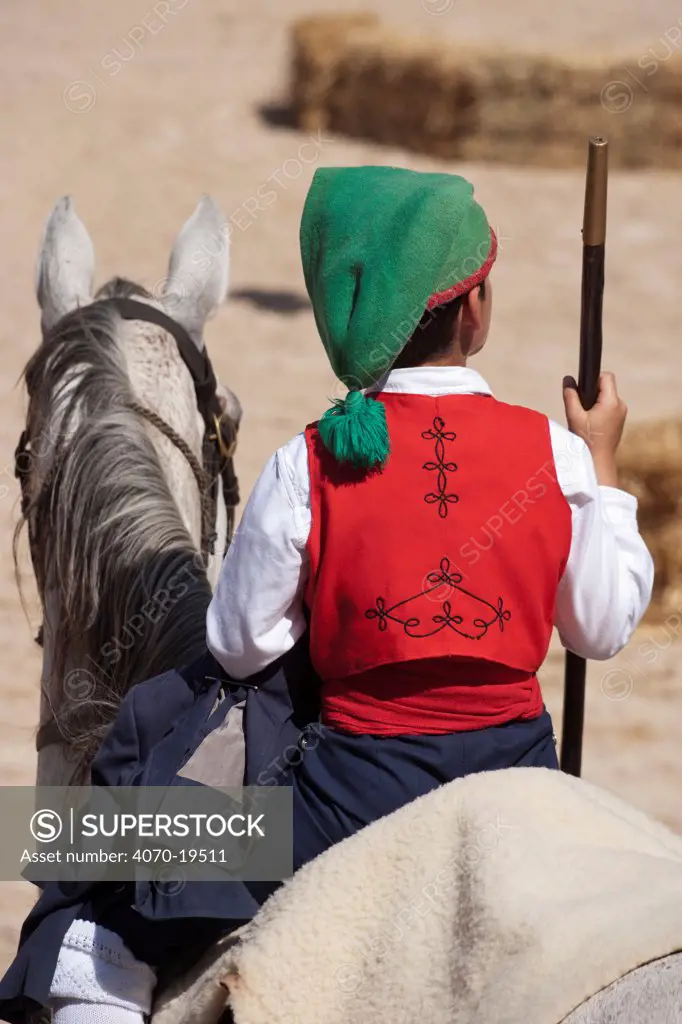 Back of a traditionally dressed cowboy mounted on his horse, during the Festa do Colete Encarnado (Red Waistcoat Festival), a bull running festival, in the bullring of Vila Franca de Xira, District of Lisbon, Portugal, July 2011.