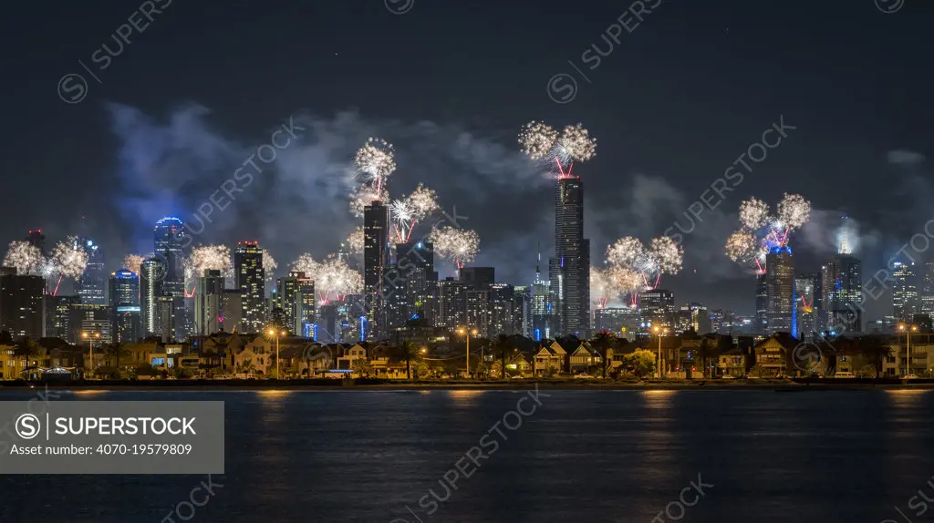 Fireworks over Melbourne city skyline for New Year celebrations. View from Port Philip Bay, St Kilda, Victoria, Australia. January 2018.