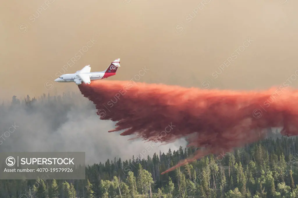 Fire fighting activities with fixed wind aircraft dropping fire retardant on the Lava Mountain Fire, Wyoming, USA. July 2016