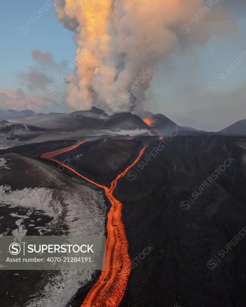 Red hot lava flow and an ash plume erupting Plosky Tolbachik Volcano, Kamchatka Peninsula, Russia, 5 December 2012