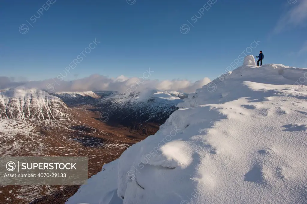 Hillwalker on the the summit of Tom na Gruagaich in winter, Beinn Alligin, Torridon, Scotland, UK, February 2010 Model Released