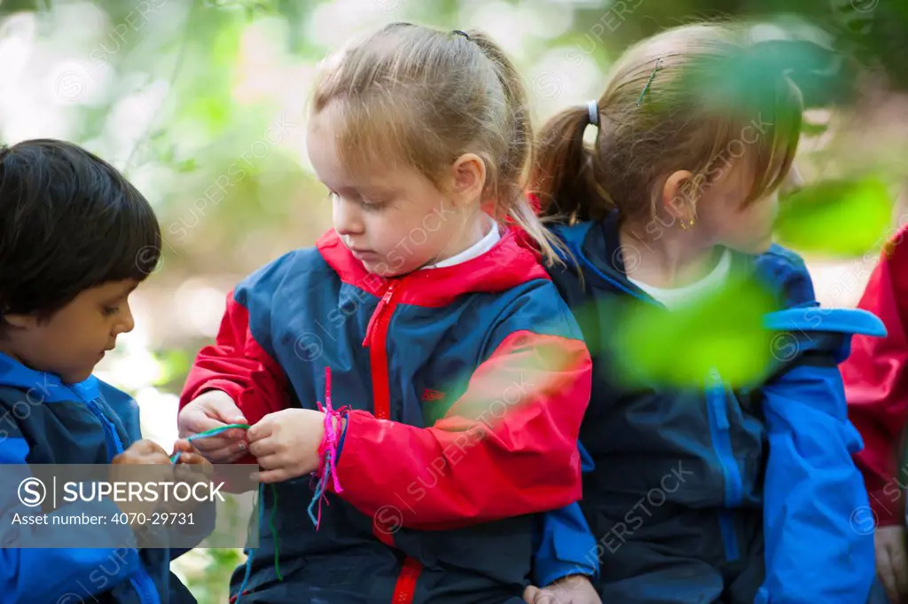 Children from Rowley View Nursery School exploring nature at the Moorcroft Environmental Centre Forest School, Moorcroft Wood, Moxley, Walsall, West Midlands, July 2011. Model released.