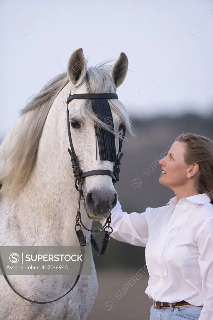 Woman with Grey Andalusian stallion, Ojai, California, USA, model released