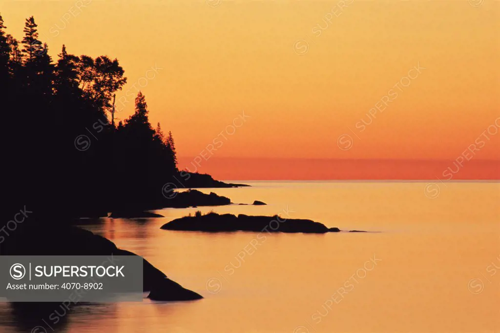 Coastline silhouetted at sunset, Isle Royale NP, Lake Superior, Michigan, USA
