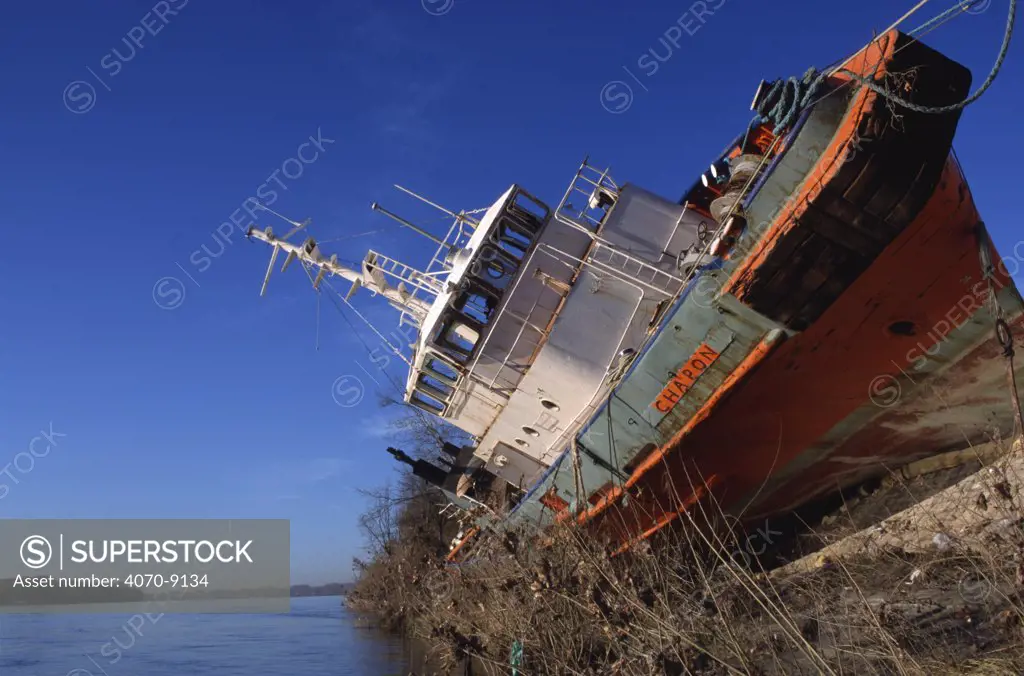 Boat deposited on land by flooded River Rhone, Arles, Camargue, France, December 2003