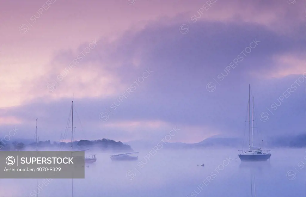 Boats on Windermere at dawn, Bowness-on-Windermere, Lake District National Park, Cumbria, England, UK