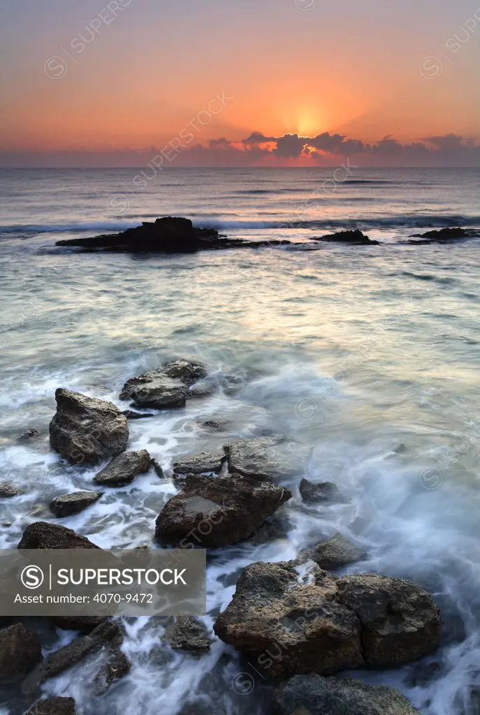 Sunset over rocky shore, Spain
