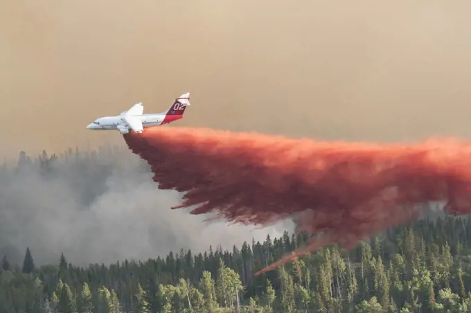 Fire fighting activities with fixed wind aircraft dropping fire retardant on the Lava Mountain Fire, Wyoming, USA. July 2016