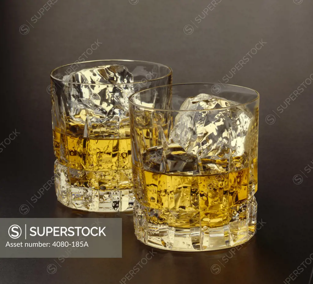 Two glasses of scotch with ice cube
