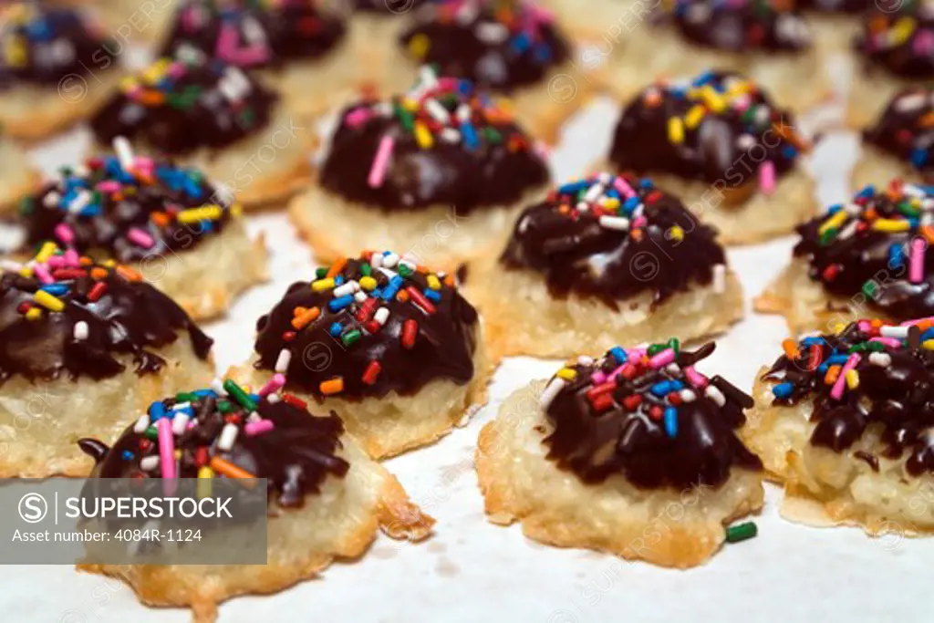 Macaroon Cookies Dipped in Chocolate With Colorful Sprinkles