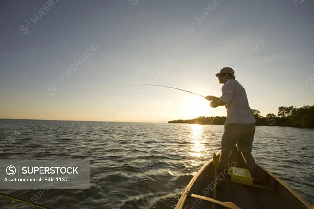 Man Casting Fishing Rod From Boat, Florida Keys, USA