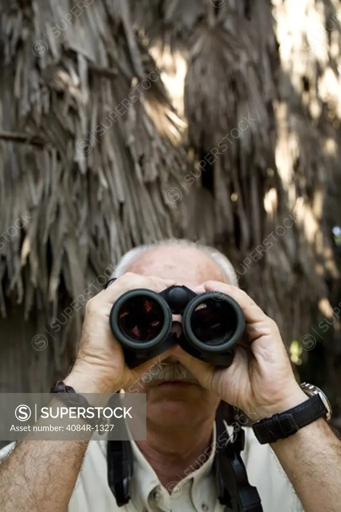 Balding Eldery Man With Moustache Looking Through Binoculars