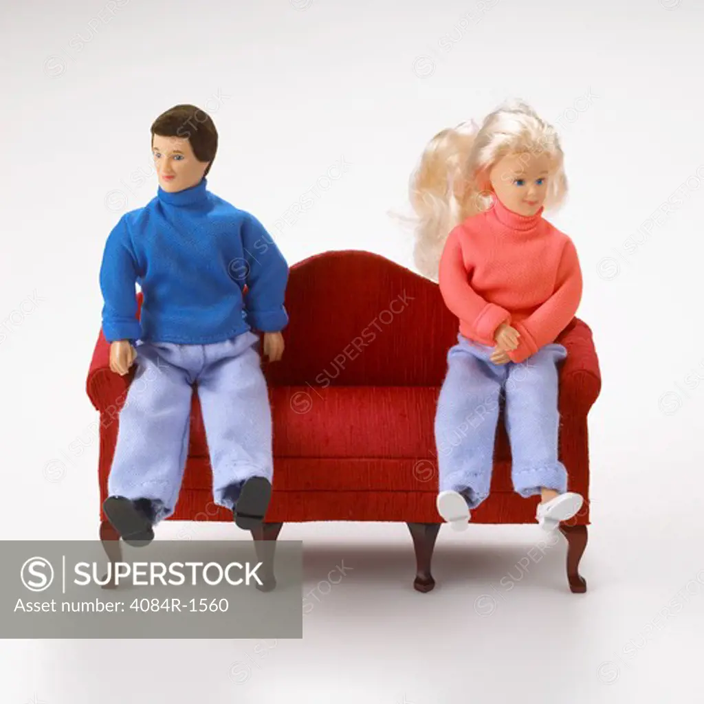 Male and Female Dolls Sitting on Miniature Couch