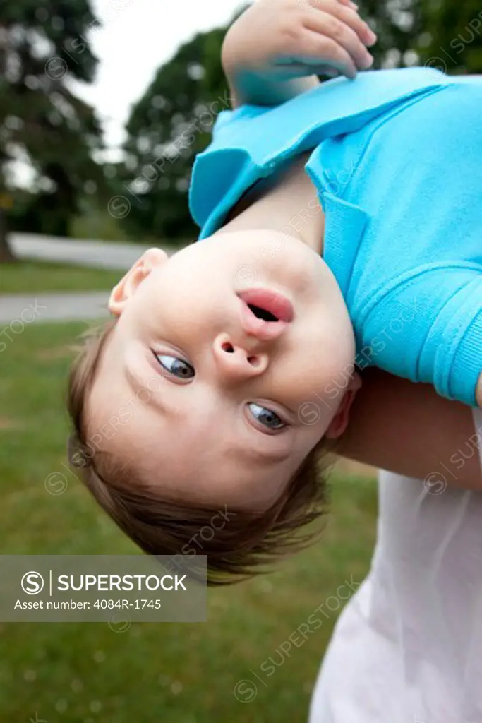 Young Boy Upside Down and Looking Away