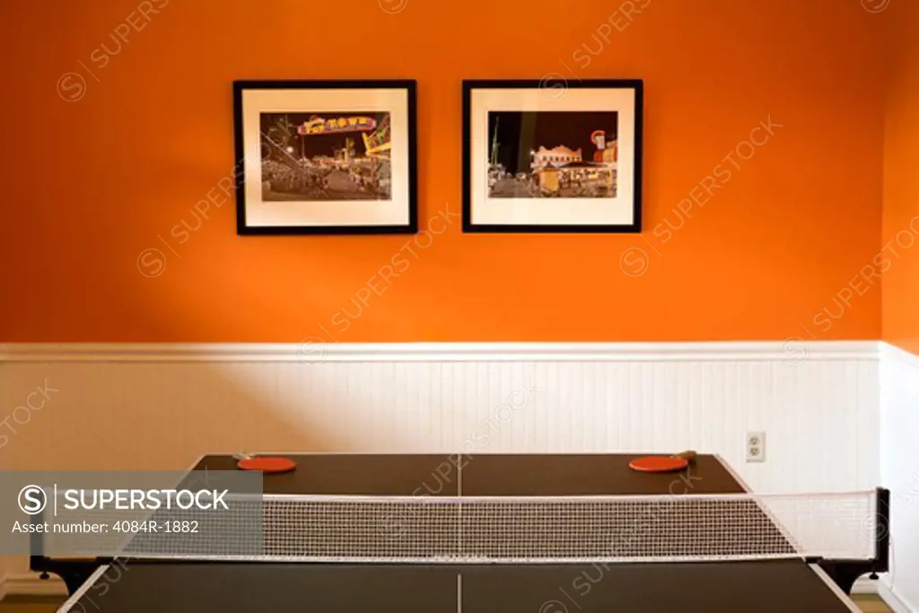Ping Pong Table and Framed Photos on Wall