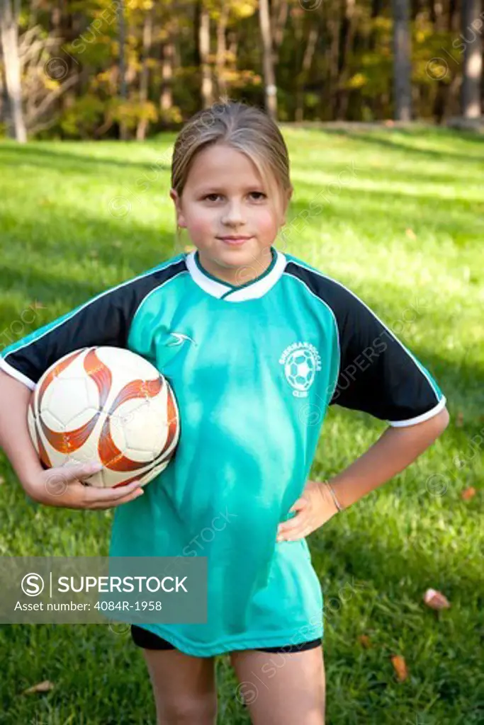 Young Girl Holding Soccer Ball, Close-Up