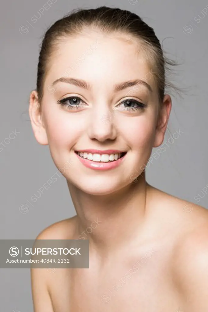 Smiling Teenage Girl With Blonde Hair Pulled Back, Portrait,