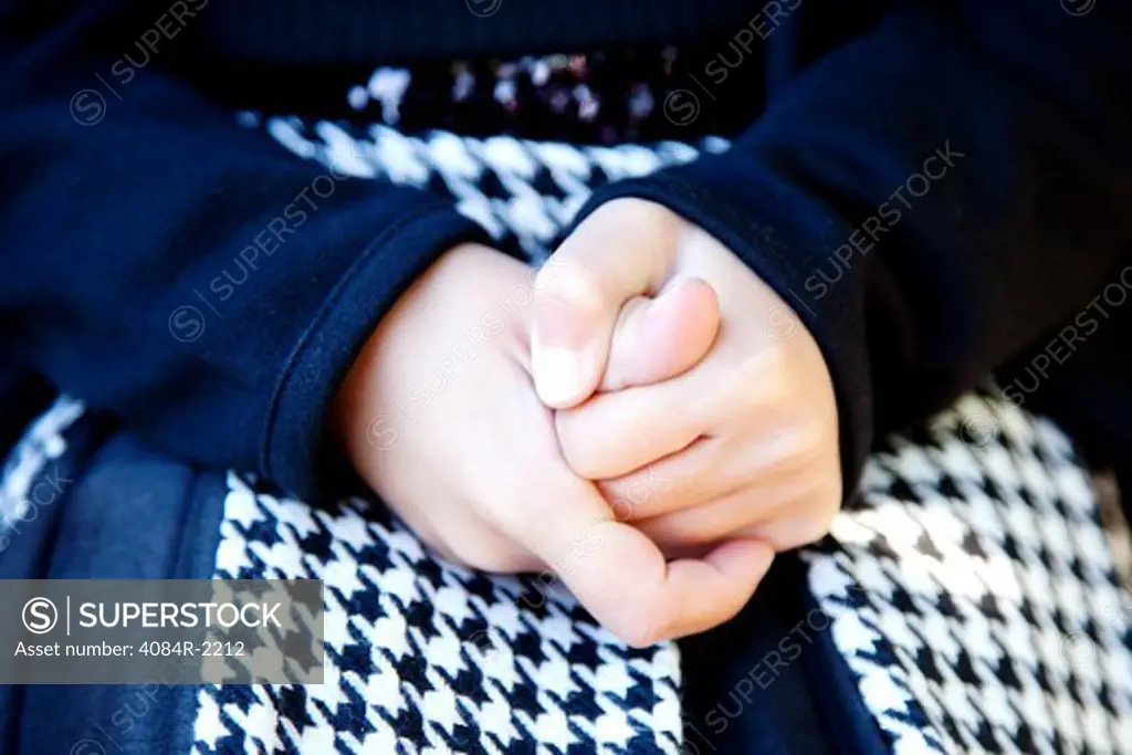 Girl Holding Hands Together in Lap