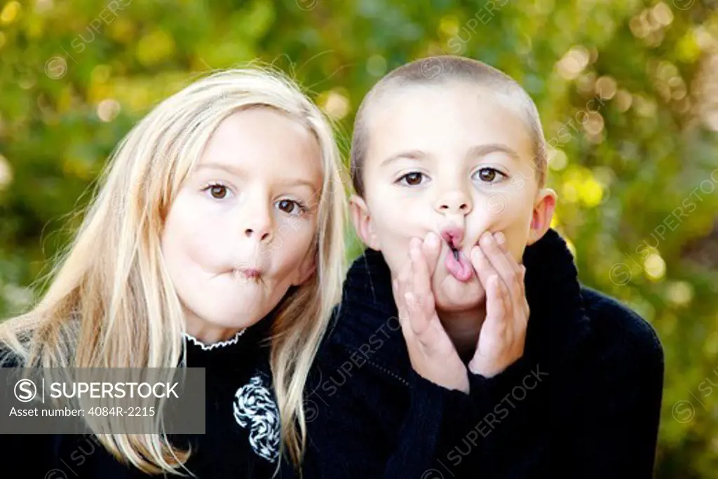 Boy and Girl Making Funny Faces