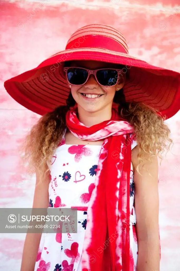 Smiling Girl in Red Floppy Hat and Sunglasses