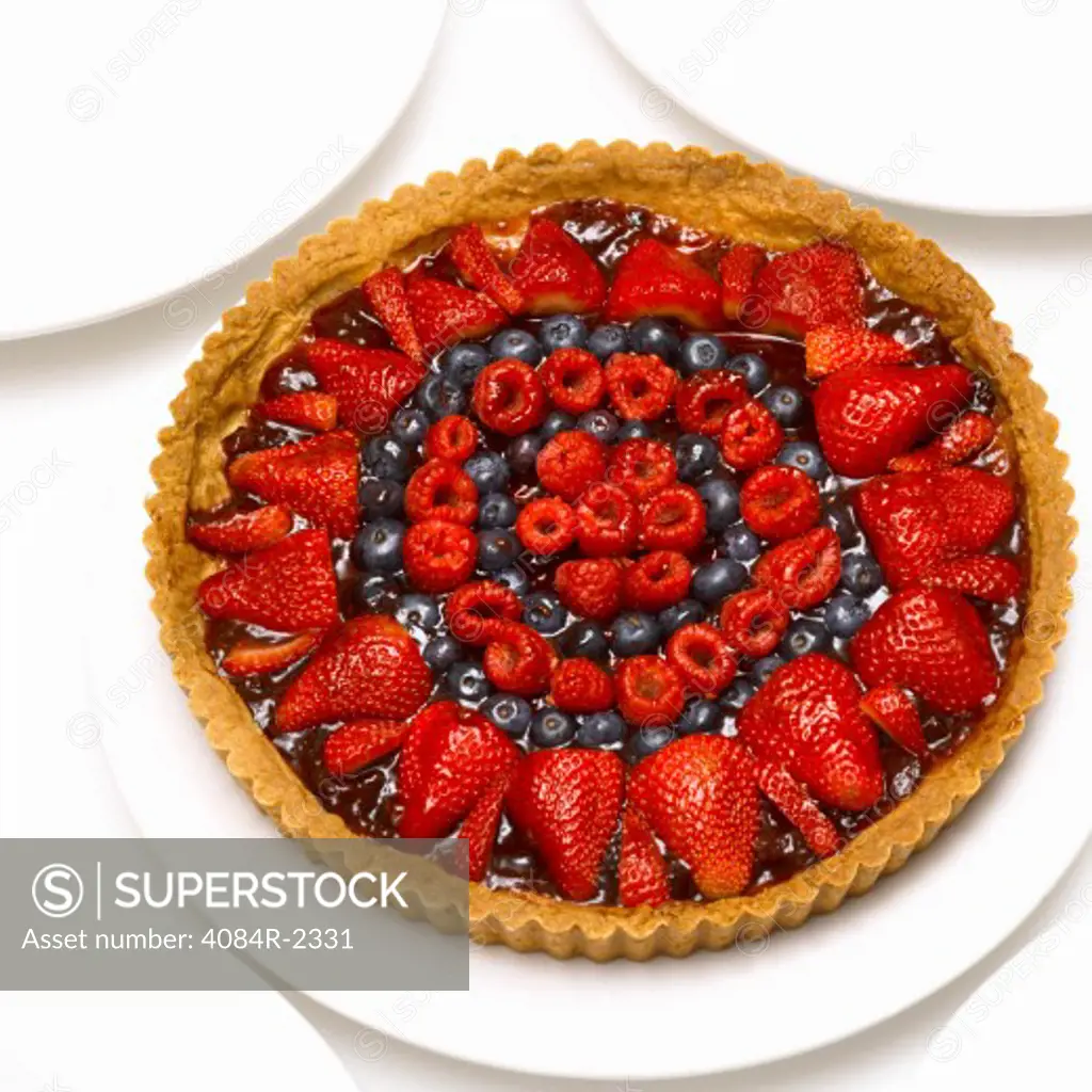Raspberry, Blueberry & Strawberry Tart on White Plate, High Angle View