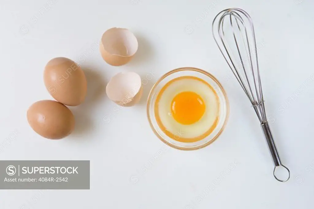 Raw Egg in Bowl with Whisk