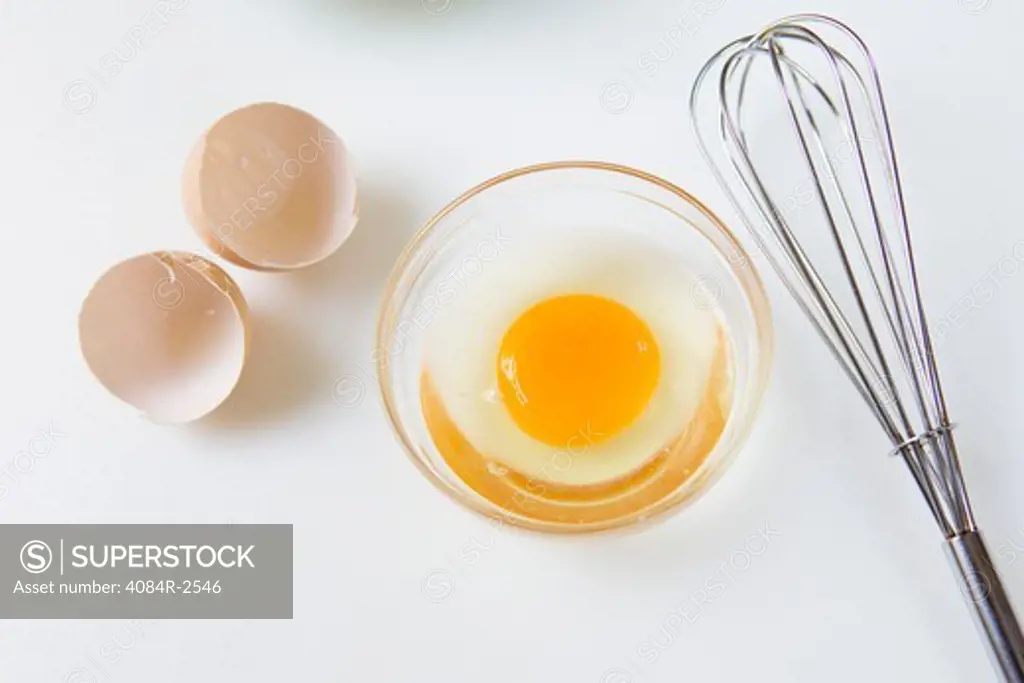 Raw Egg in Bowl with Whisk