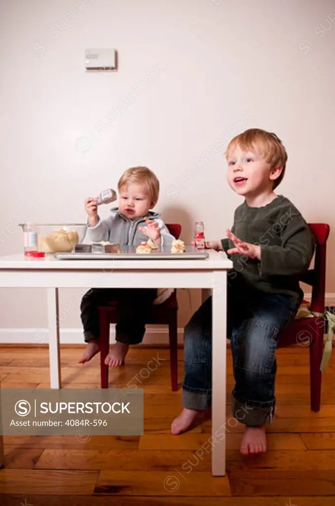 Two Young Boys Making Cookies