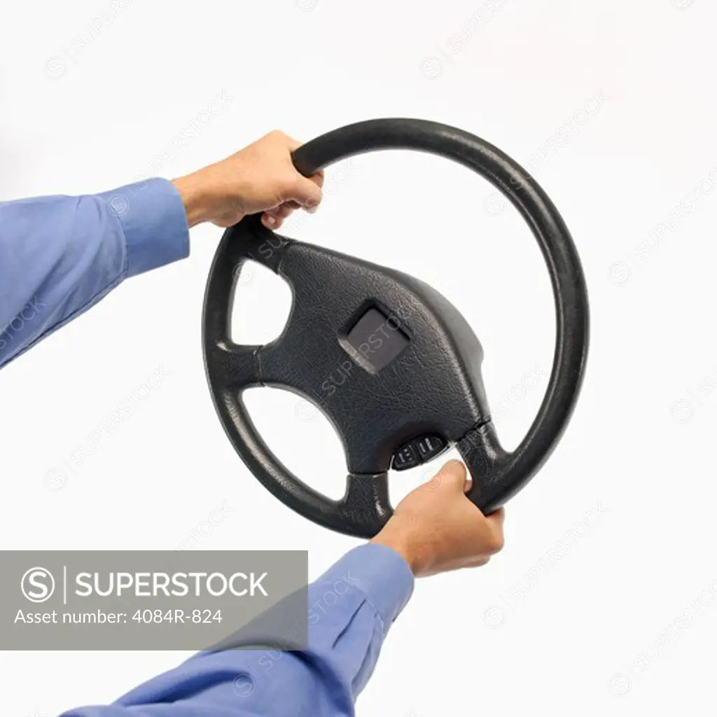 Man's Hands Holding Steering Wheel