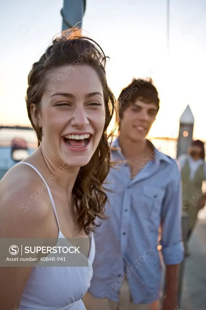 Laughing Young Woman on Boat, Portrait, With Young Man in Background