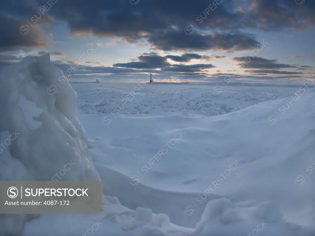Frozen lake with a lighthouse in the background, Lake Michigan, Frankfort Lighthouse, Frankfort, Benzie County, Michigan, USA