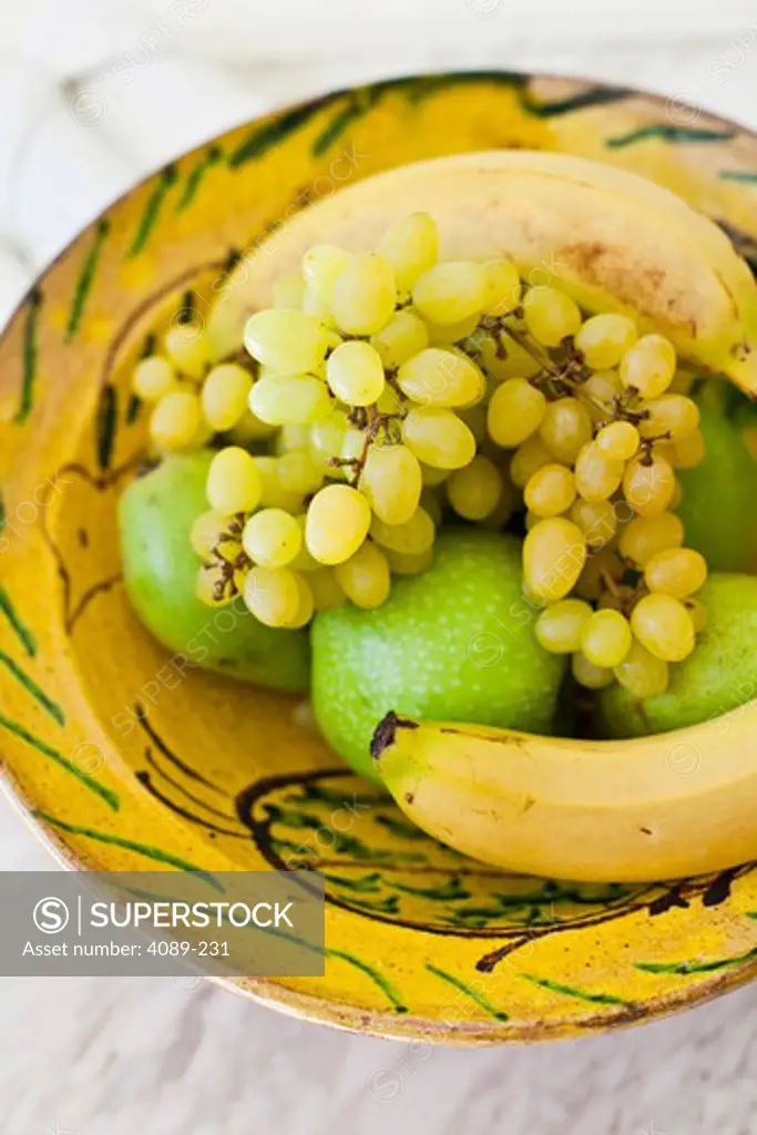 Close-up of fruits in a painted bowl