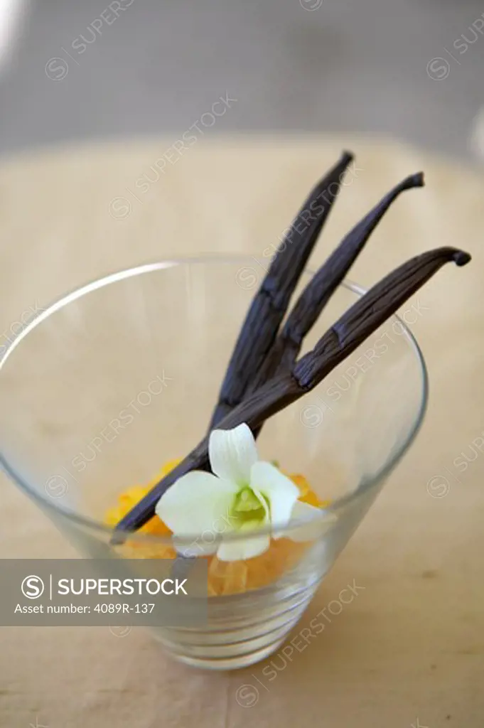 Vanilla bean with flower and sugar in a glass