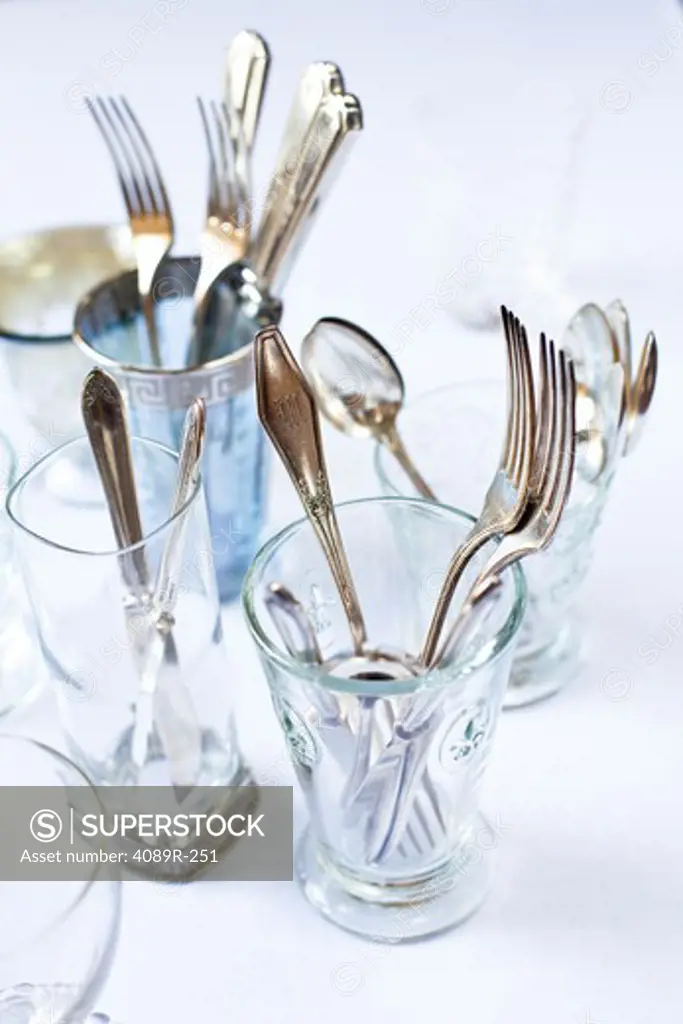 Antique silverware and glasses on a dining table