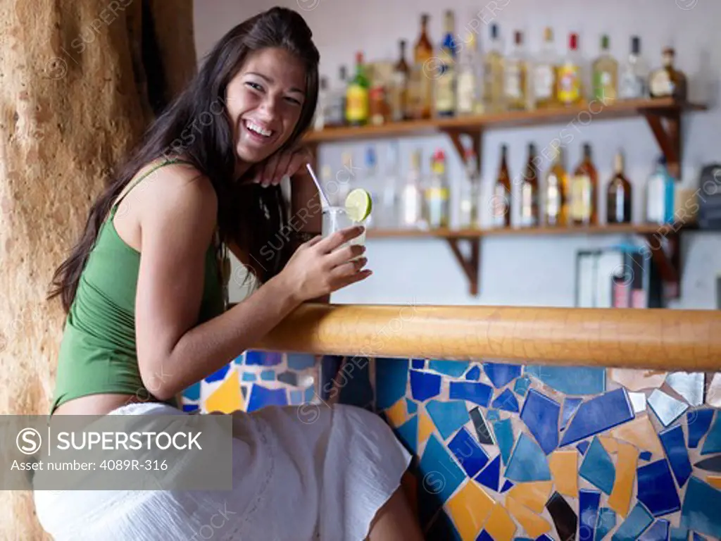 Mexico, Yucatan Peninsula, Quintana Roo, Tulum, Young woman drinking glass of margarita in bar