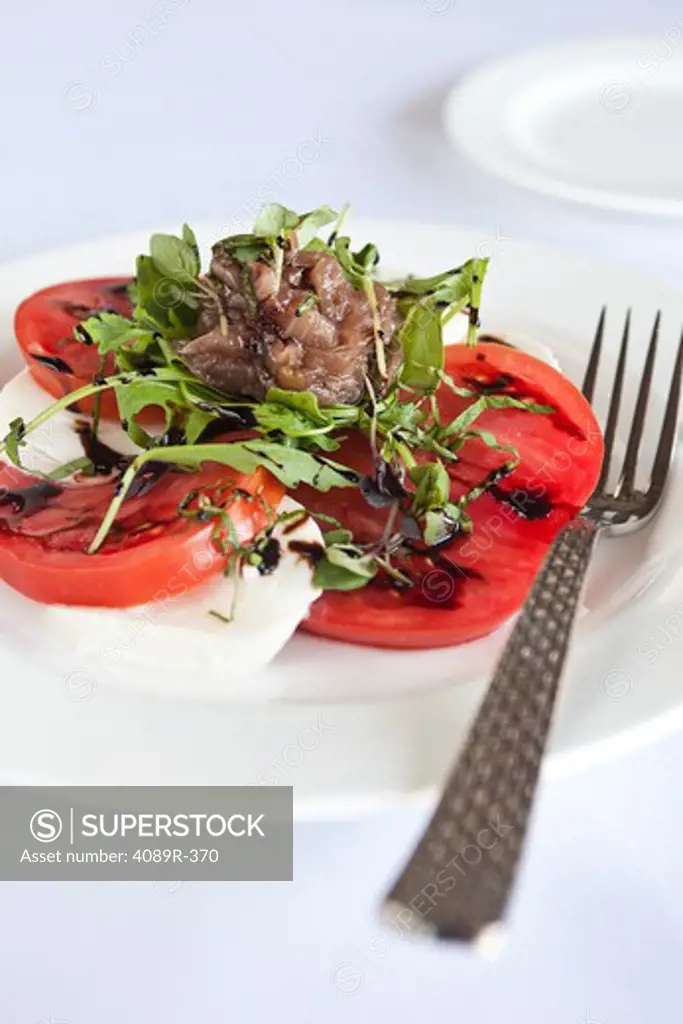 Caprese salad with Heirloom tomatoes, buffalo mozzarella balsamic reduction and basil chiffonade