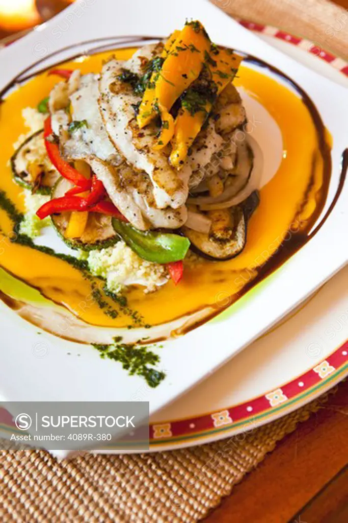Mexico, Yucatecan, close up of Mayan fish with peppers, papaya and zucchini