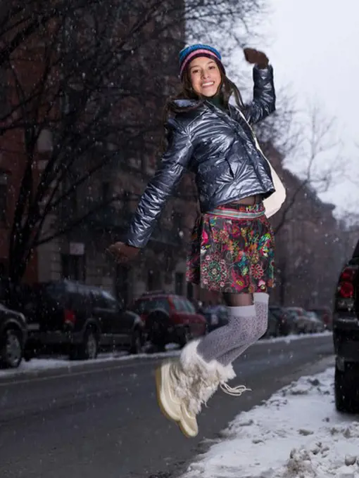 Teenage girl jumping on the road, New York City, New York State, USA
