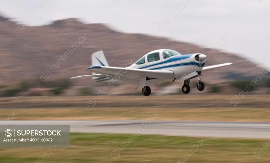 A Meyers 200D departing Flabob airport in Riverside, CA. The Meyers 200 is a single engine piston airplane and was designed by Al Meyers in the late 1950's and built by the Meyers Aircraft Company until 1965. Aero Commander then built them until 1967. It has a cruise speed of 210 mph and is considered one of the fastest airplanes in it's class.