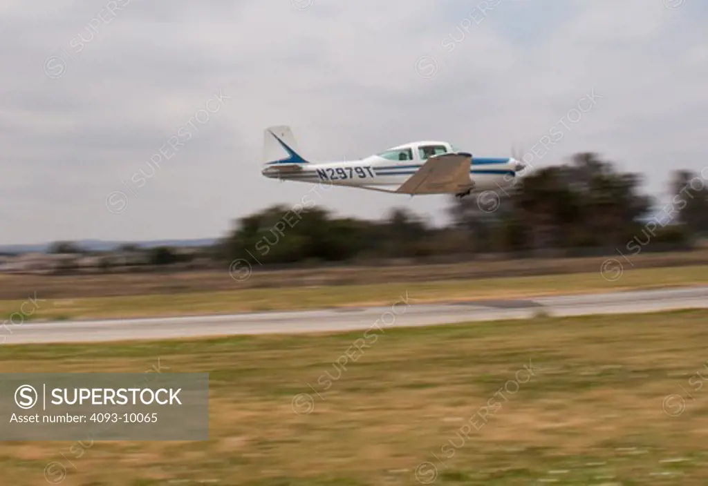 A Meyers 200D performing a low pass at Flabob Airport in Riverside, CA.  The Meyers 200 is a single engine piston airplane and was designed by Al Meyers in the late 1950's and built by the Meyers Aircraft Company until 1965. Aero Commander then built them until 1967. It has a cruise speed of 210 mph and is considered one of the fastest airplanes in it's class.