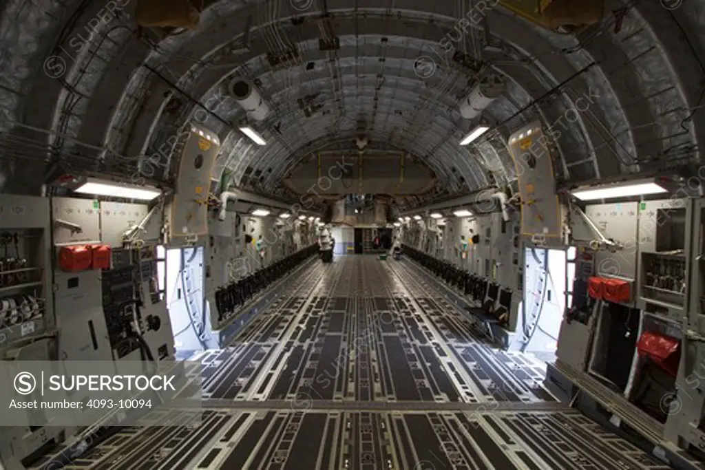 Interior view of the cargo area of a Boeing C-17 (formerly McDonnell Douglas). The C-17 Globemaster III is a large military transport aircraft. It was developed for the United States Air Force and is used for rapid strategic airlift of troops and cargo to main operating bases or forward operating base anywhere in the world. It has the ability to rapidly deploy a combat unit to a potential battle area and sustain it with on-going supplies.