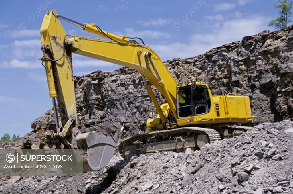 excavator yellow earth mover rocks rocky