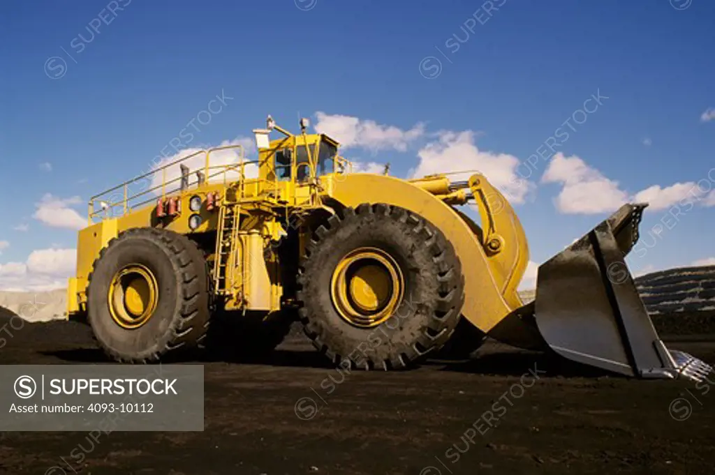 low angle front loader earth mover yellow