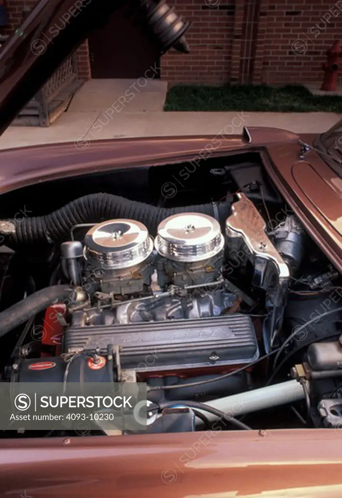 An overall engine view of a Chevrolet Corvette C1 1956 1950s V8 engine / motor 283 cubic inch turbo-fire small block showing the valve cover rocker cover and the air filter.