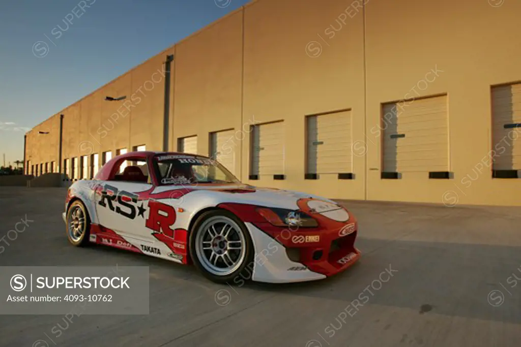 2004 Honda s2000 s-2000 Hardtop racing version race type   S2000 features a front-mid-engine, rear wheel drive layout with power being delivered via a Torsen limited slip differential mated to a six-speed manual transmission.  The S2000 comes with an electrically powered cloth top, and an OEM hardtop is also available.  The 2004 model introduced newly designed 17 wheels and Bridgestone RE-050 tires along with a retuned suspension that reduced the car's tendency to oversteer. The spring rates and